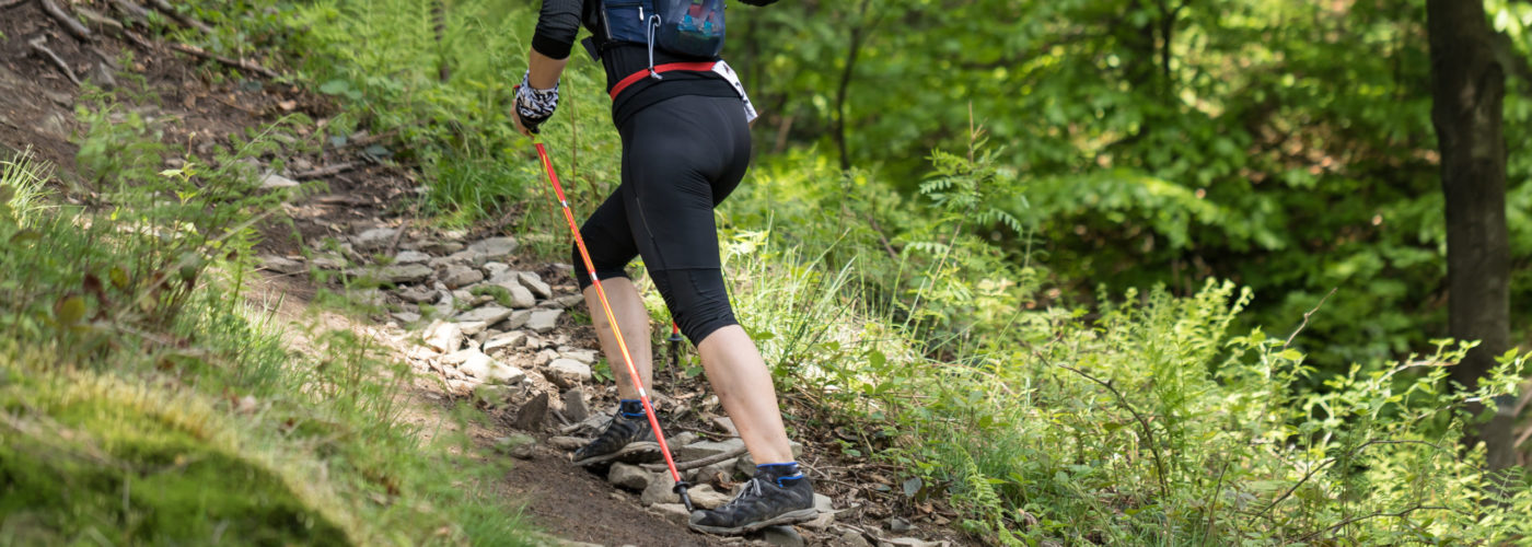 Woman hiking in woods wearing leggings