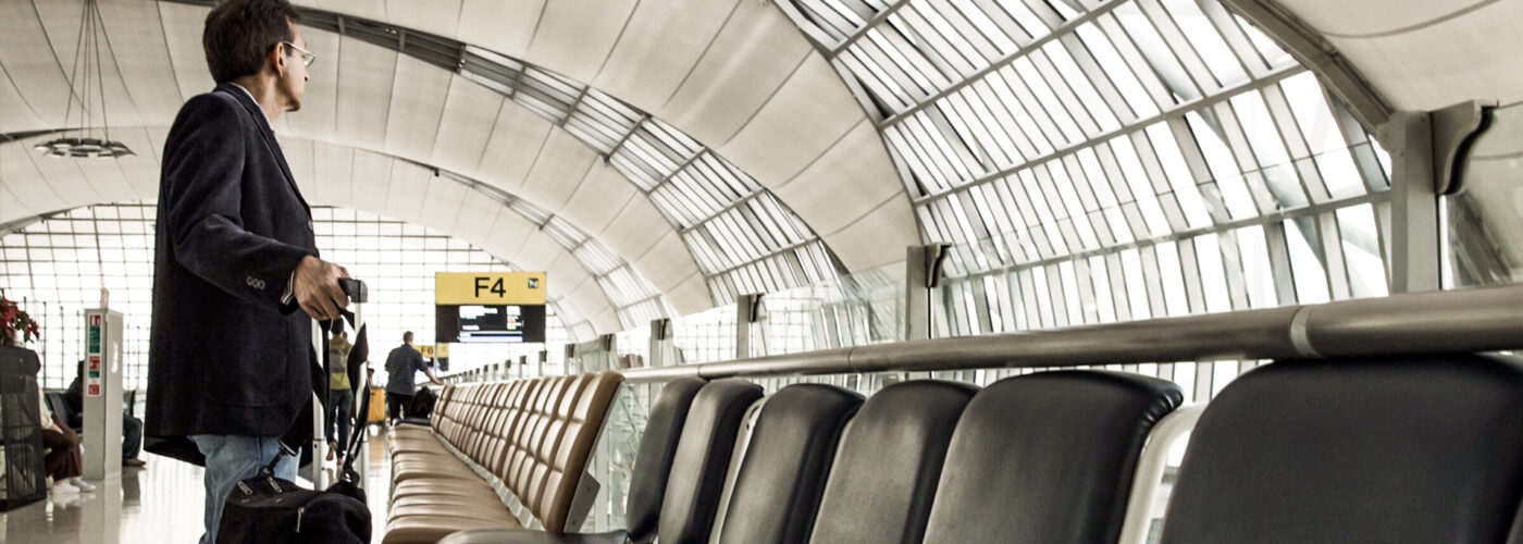 business man with luggage airport seating area